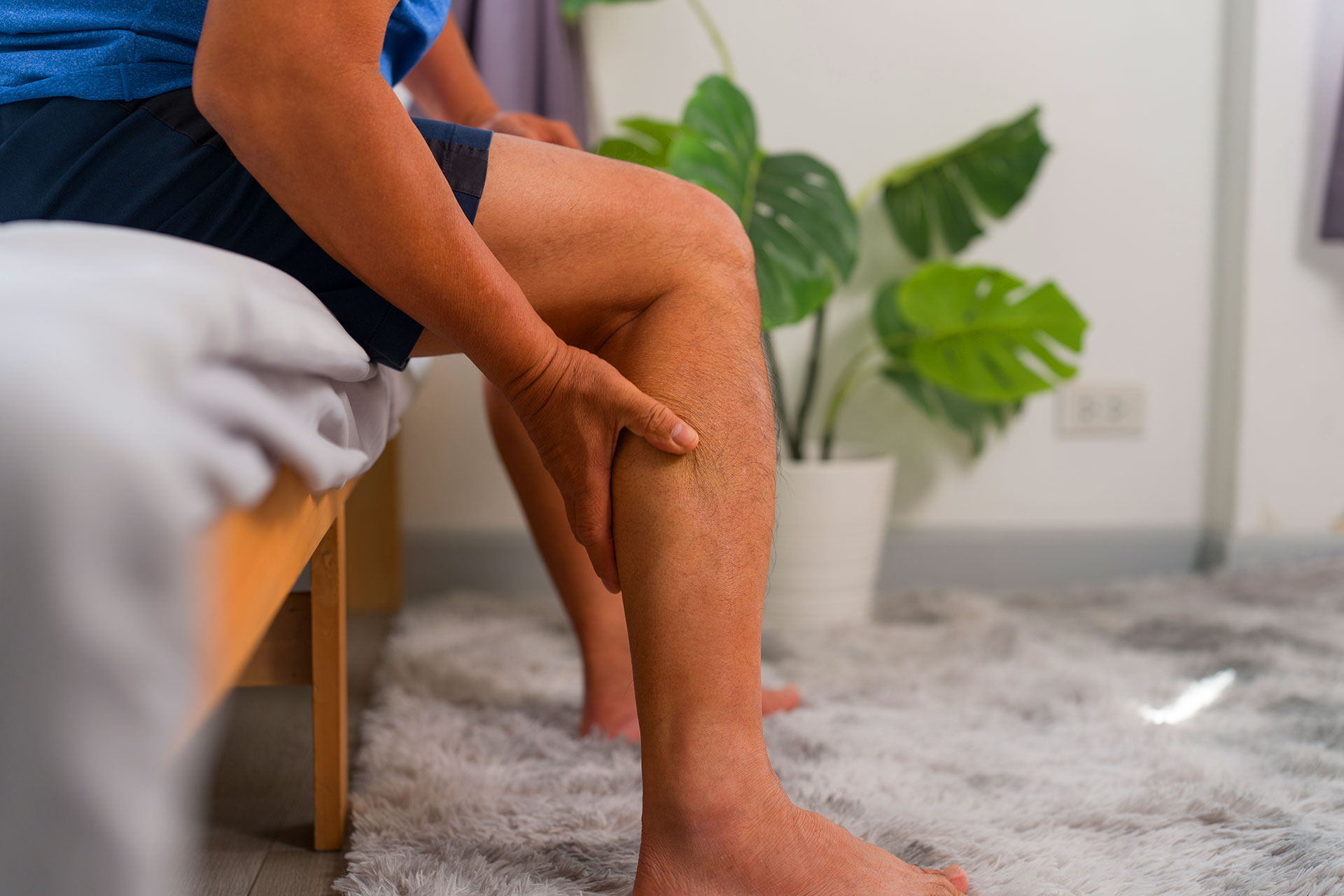 Woman experiencing heavy tired legs caused by venous insufficiency