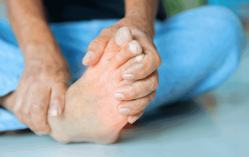 Person massaging a swollen foot caused by heat edema and fluid buildup.