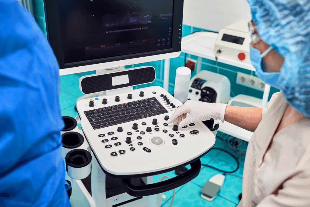 Doctor operating a vascular ultrasound machine used to diagnose a ruptured vessel in leg.