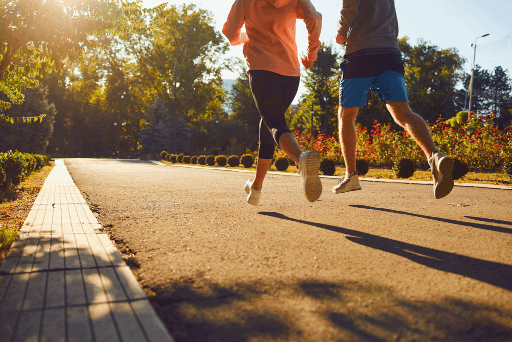 People jogging outdoors, an activity that promotes circulation and helps prevent issues like a ruptured vessel in leg.